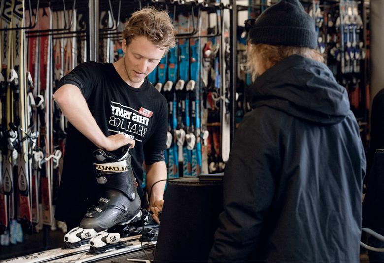 fitting bindings to a ski at a sports rental shop in Chamonix