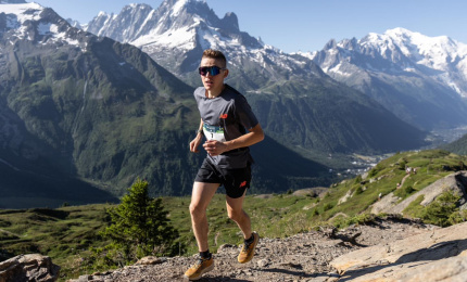 Runner with Mont-Blanc, Chamonix Aiguilles, Le Dru and La Verte all in background during Mont-Blanc Marathon 2025